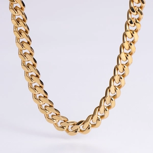 Detailed close-up of heavy gold-plated stainless steel Cuban link chain with high polish