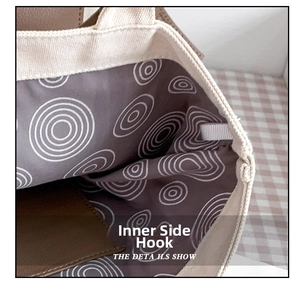 Detail view of the inner hook and purple geometric pattern lining in a canvas tote bag
