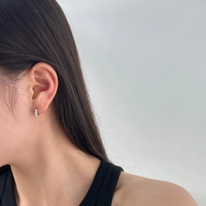 Close-up of S925 sterling silver hoop earrings with zircon heart charm on model ear