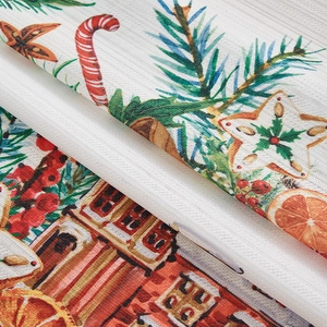 Detail of Christmas curtain fabric with candy cane, pine, and orange print texture