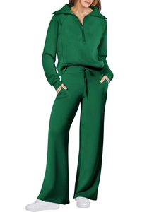 Detail view of green two-piece tracksuit with half-zip sweatshirt and wide-leg joggers