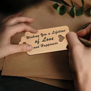 Close-up of wooden heart gift tag with engraved blessing for wedding and party favors
