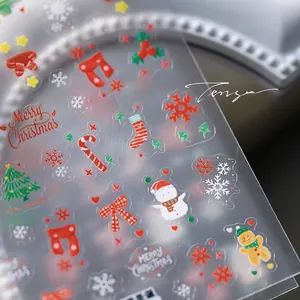 Detailed macro view of 3D embossed Christmas nail stickers featuring festive puppy patterns