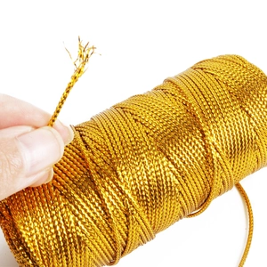 Close-up of 1.5mm gold metallic thread showing detailed spiral woven texture for DIY crafts
