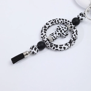Silicone cross car pendant with leopard print beads, black tassel and rhinestone accents