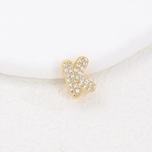 Detailed close-up of gold-plated letter K pendant encrusted with sparkling white zircons