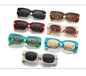 Multiple colorful rectangular sunglasses featuring gold metal chain temples on white background