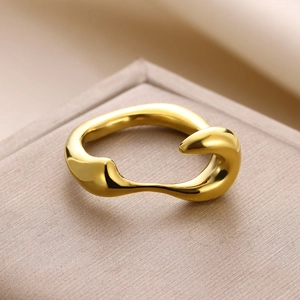 Detailed macro shot of irregular golden ring with a polished liquid metal texture