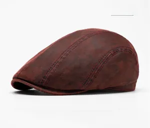 Detailed close-up of dark red vintage beret featuring distressed faux leather texture