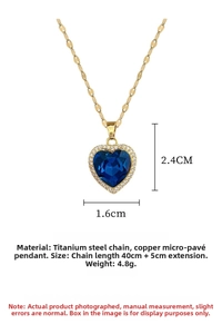 Detailed close-up of golden titanium necklace with blue heart crystal and small diamonds