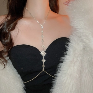 Detail of elegant silver rhinestone body chain with rhombus pendants on a female model