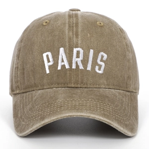Close-up of PARIS embroidery on vintage washed khaki cotton canvas baseball cap