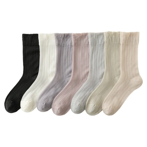 Set of 7 breathable cotton crew socks in pastel colors with ribbed texture and rolled cuffs