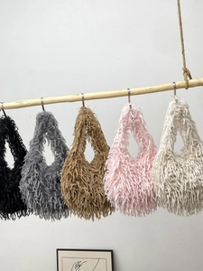 Chic faux fur shoulder bags in five colors hanging on a wooden rod for autumn winter style