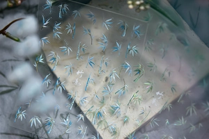 Macro detail of laser holographic bamboo leaf nail stickers with metallic finish