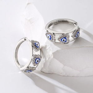 Silver hoop earrings with blue evil eye heart charms and sparkling zircon accents