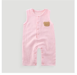 Close-up of pink cotton gauze baby bodysuit with bear patch and snap buttons