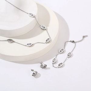 Detailed set of silver finish 18K plated necklace bracelet and earrings with marquise crystals