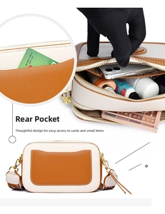 Detail view of contrast camera bag with dual zippers and woven wide shoulder strap