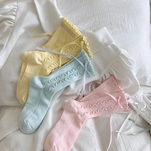 Detail of ruffle trim cotton socks with ribbon bows in four macaron colors