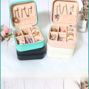 Detailed interior of portable PU jewelry box showing ring slots and necklace hooks