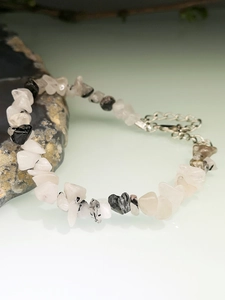 Detail view of irregular clear quartz bracelet with black tourmaline inclusions and lobster clasp