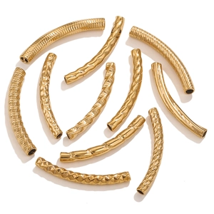 Macro detail of 18K gold plated stainless steel textured curved tubes for DIY jewelry