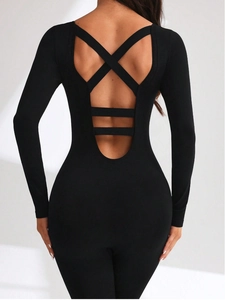 Close-up of black seamless bodysuit featuring deep U-back and X-shaped cross straps