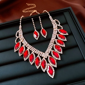 Detailed set of red marquise gemstone necklace and earrings on a black display stand