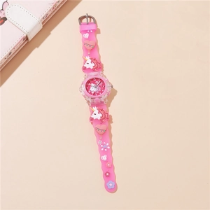 Close-up of pink unicorn quartz watch featuring embossed silicone strap and numerals