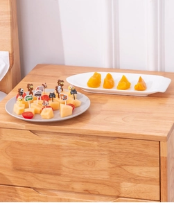 Close-up of cute cartoon car and bear food picks used for snacks in a home setting