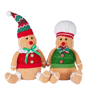 Pair of plush Christmas gingerbread gnomes with chef hats for holiday home decoration
