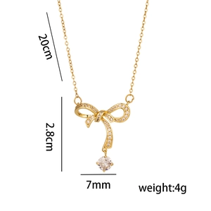 Gold bow necklace with cubic zirconia pendant and specific dimensions and weight details