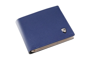 Macro shot of dark blue cross-grain leather wallet with beige interior and metal shield logo