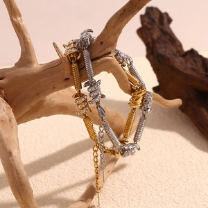Hip hop style 18K gold and silver plated knot bracelets with crystals on a wooden branch