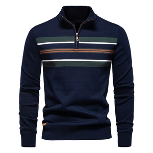 Detailed knit texture of navy half-zip sweater with green and orange stripes