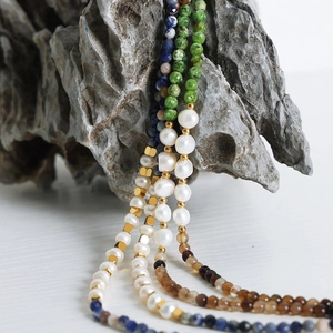 Chic multi-layered necklace with colorful natural stones and freshwater pearls on stone decor
