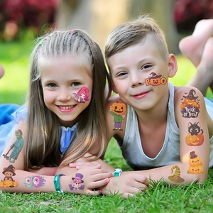 Kids wearing colorful Halloween pumpkin and ghost temporary tattoos in a sunny outdoor park