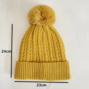 Detailed knit pattern and dimensions of yellow winter beanie with faux fur pompom