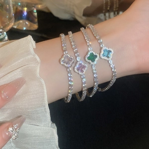 Detailed view of four-leaf clover bracelets with colorful zircon and pavé crystals