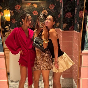 Detailed view of sexy leopard print satin slip dress worn by models in a group setting