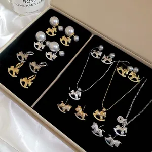 Elegant rocking horse jewelry set with pearls and crystals in gold and silver finish