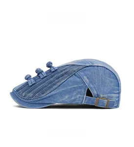 Detail view of washed denim newsboy cap with traditional knot buttons and metal buckle