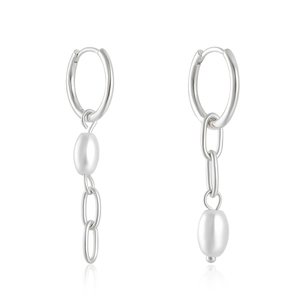 Macro shot of asymmetric S925 silver earrings with long chain tassels and white pearls
