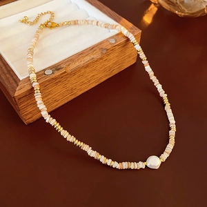 Detail of 14K gold plated necklace with baroque pearl and shell beads in wood box