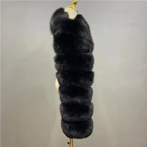 Detail view of the dense black faux fur texture and horizontal stitching on this long vest
