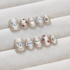 Handmade press-on nails featuring cute cartoon dogs and Lucky text on nude cat-eye base