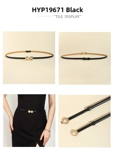 Detail view of black skinny belt featuring a golden ring buckle with pearl accent and tile display