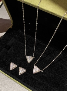 Macro detail of triangle jewelry set with cubic zirconia in a velvet gift box