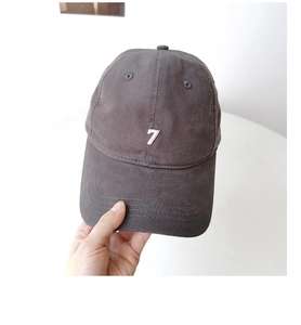 Detailed embroidery of the number seven on a dark grey washed cotton baseball cap